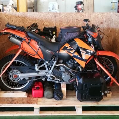 KTM adventure bike inside a wooden crate, front view