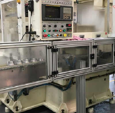 CNC machine with control panel on a factory floor